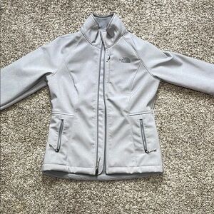 The North Face Gray Ski Jacket with High Collar and Fitted Silhouette